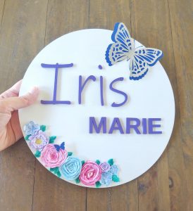 Custom wall hanging with laser-cut letters and sculptural paint flowers